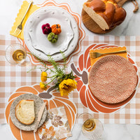 Pumpkin paper placemats on a Fall table setting.