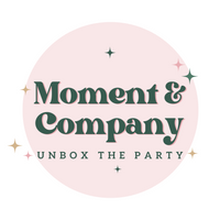 Moment & Company logo with a playful tagline "Unbox the Party", representing festive Thanksgiving tableware and party decorations collections.