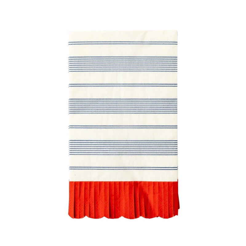 Blue striped paper dinner napkins with red scalloped fringe edge on a patriotic table.