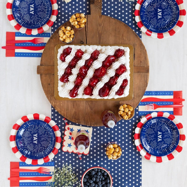 Blue paper dessert plates with a firework design and the word yay in the center - perfect for a 4th of july party or 1st birthday party.