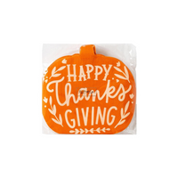 Front view of the packaged Happy Thanksgiving Pumpkin Napkins featuring a bright orange pumpkin shape with "Happy Thanksgiving" printed in white.