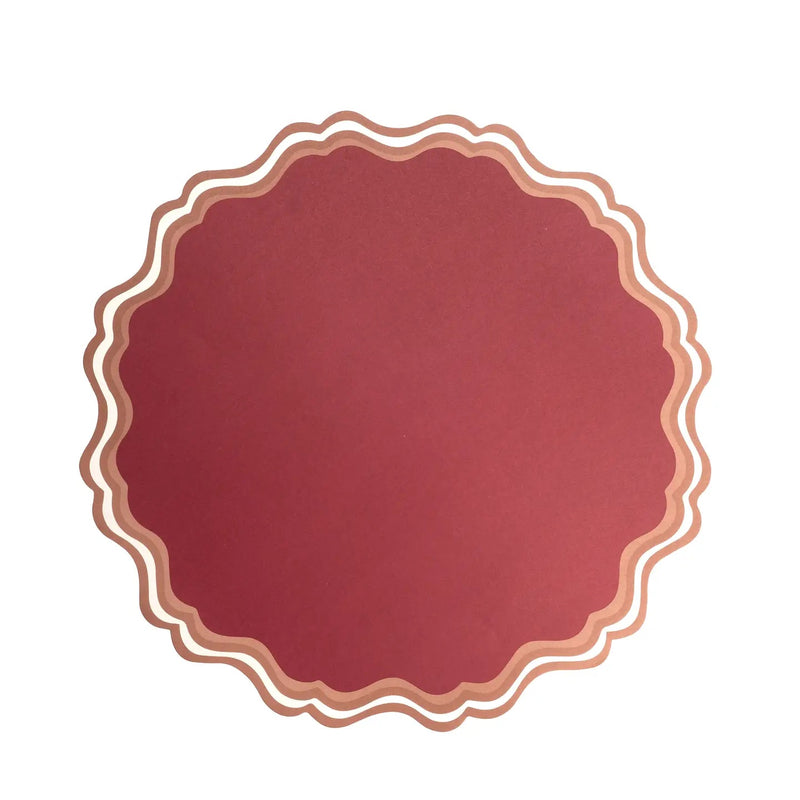 Maroon paper placemat with scalloped edges.