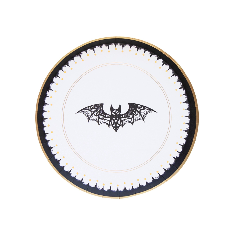 a paper dessert plate with gold and black designs featuring a lace bat