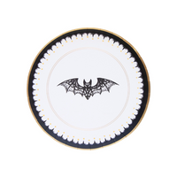 a paper dessert plate with gold and black designs featuring a lace bat