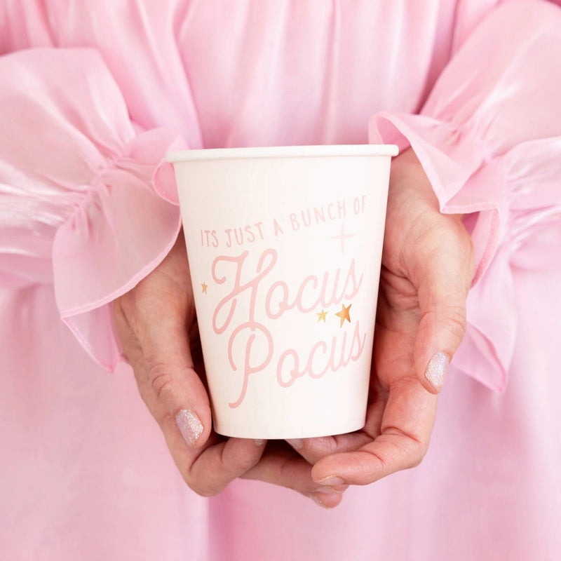 Pink paper cup with Its Just a Bunch of Hocus Pocus written in pink and gold foil stars, perfect for Halloween parties.