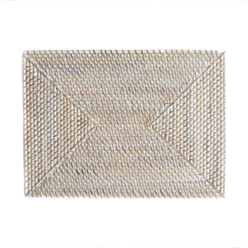 Rectangle rattan placemat in a white wash color on an Spring table. The perfect gift for someone who enjoys hosting.