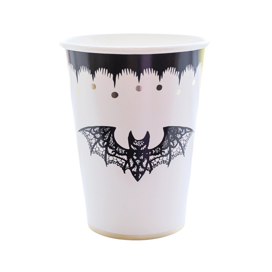 a paper cup with black and gold designs featuring a black lace bat perfect for halloween.