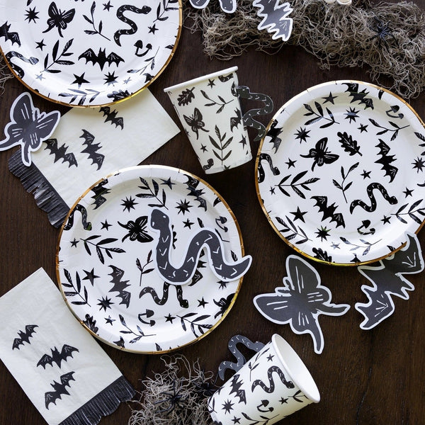 Set of 24 white Halloween napkins featuring black bats and fringe scalloped edges.