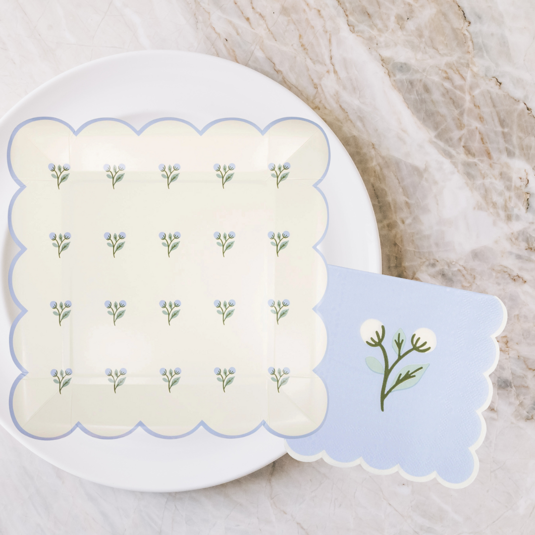 Set of floral paper plates neatly arranged for serving at a spring celebration.