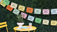 Fiesta Papel Picado Banner hanging above a Cinco de Mayo taco and margarita bar.