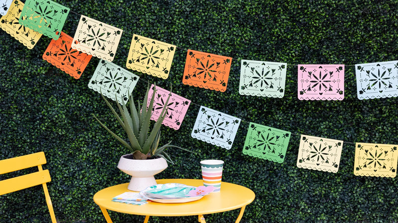 Fiesta Papel Picado Banner hanging above a Cinco de Mayo taco and margarita bar.