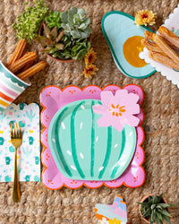 Fiesta Striped Paper Cups paired with matching plates and napkins for a colorful table setup.