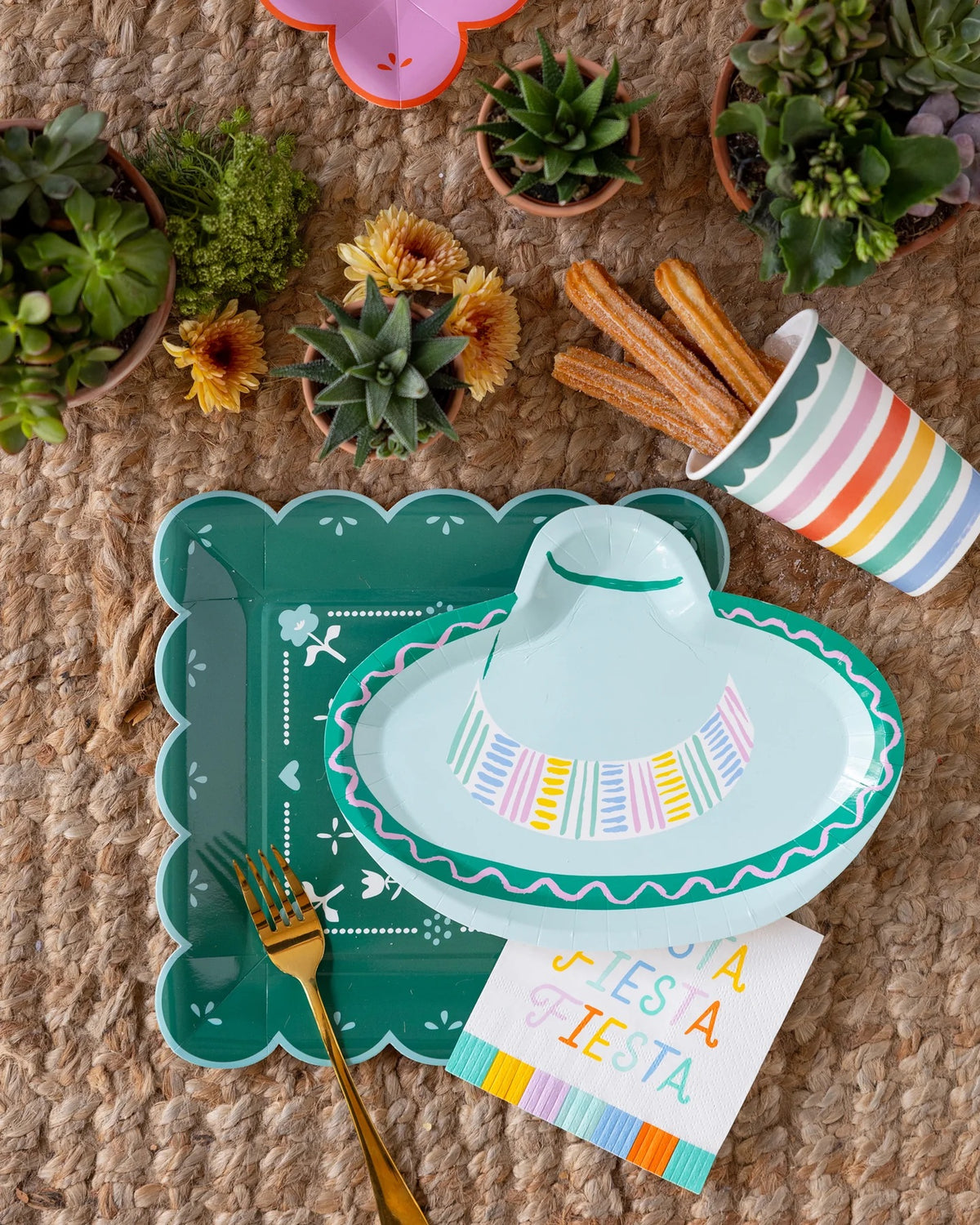 Sombrero-shaped Cinco de Mayo plates styled with tacos, drinks, and festive decor.