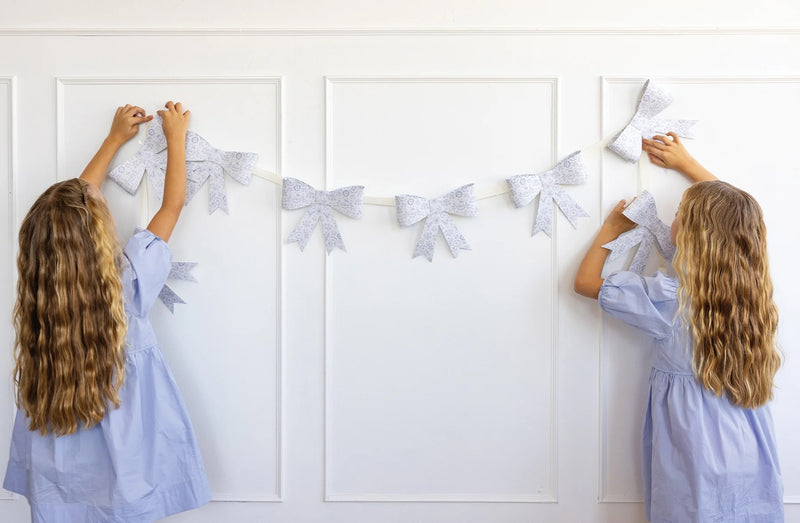 Floral Bow Banner draped across a party table with matching pastel decor.