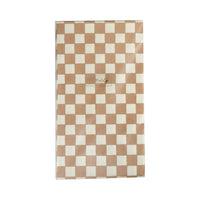 Tan and white checkered paper dinner napkins in their packaging