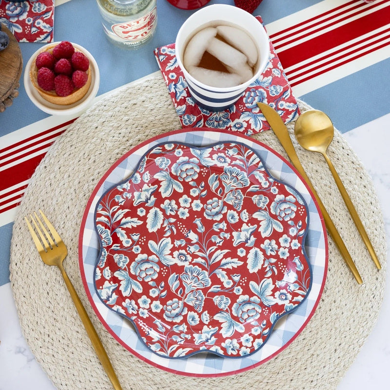 Red scalloped paper plates with a blue and white floral design - perfect for a summer picnic or a 4th of July Party.