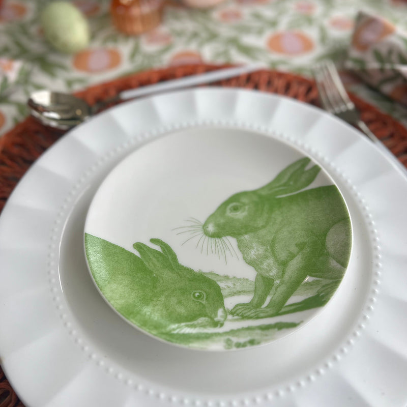 White ceramic appetizer plates with green bunny designs.