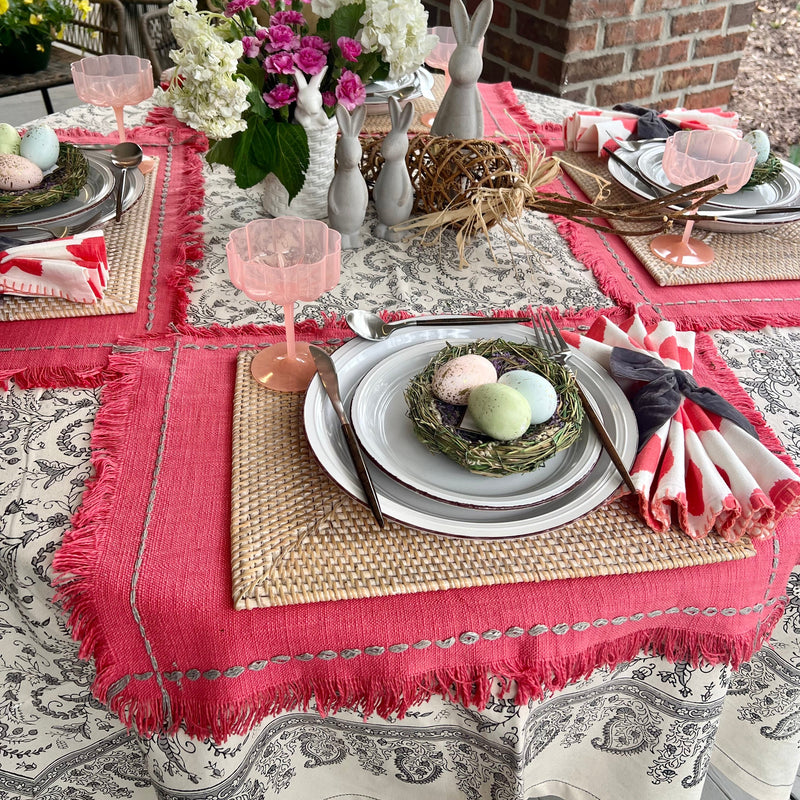 Off-white tablecloth with a gray floral design set with a Spring tablescape.