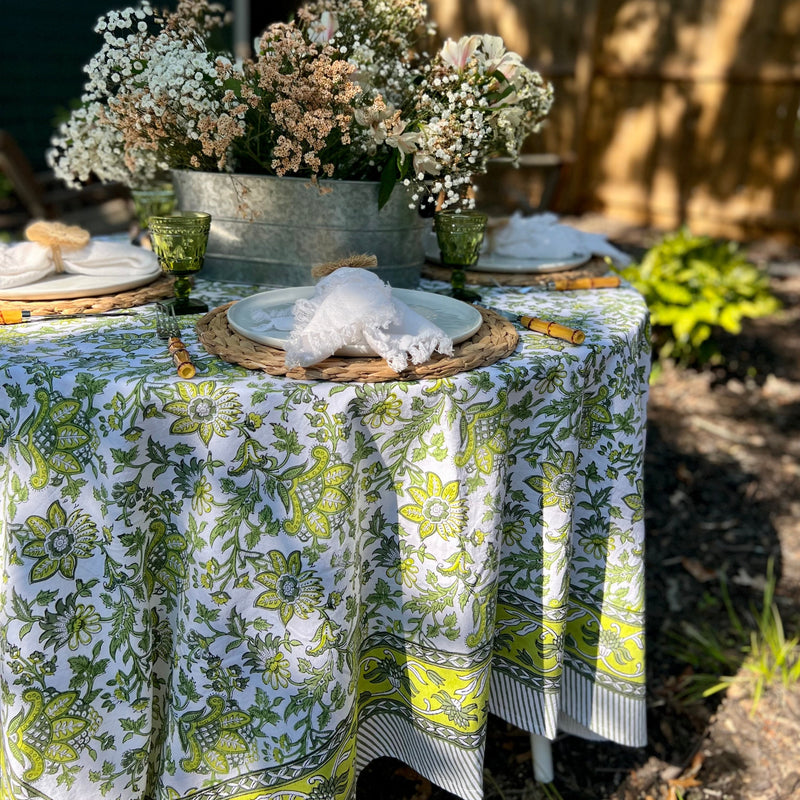 Discover the perfect backdrop for your summer celebrations with our Green Floral Tablecloth. Measuring 60"x 92", this tablecloth combines practicality with style, making it an essential addition to your garden party decor. Made from soft, durable cotton with a vibrant green and white block print, it’s not just a tablecloth—it’s a part of the party. Your guests will love this eye-catching floral tablecloth.