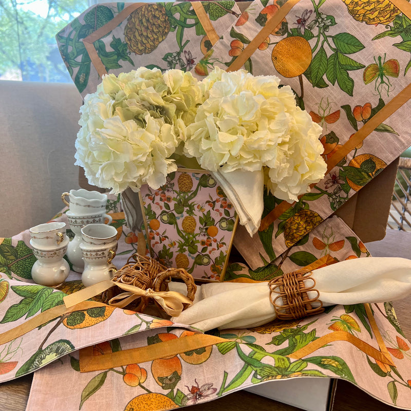 Ready to host a memorable spring event? Our Citrus Garden Tablescape Kit includes everything you need: fun pineapple, lime, and orange placemats, a chic vase, rattan rings, and tan napkins. This all-in-one kit is your quick solution to creating a vibrant and inviting spring tablescape.