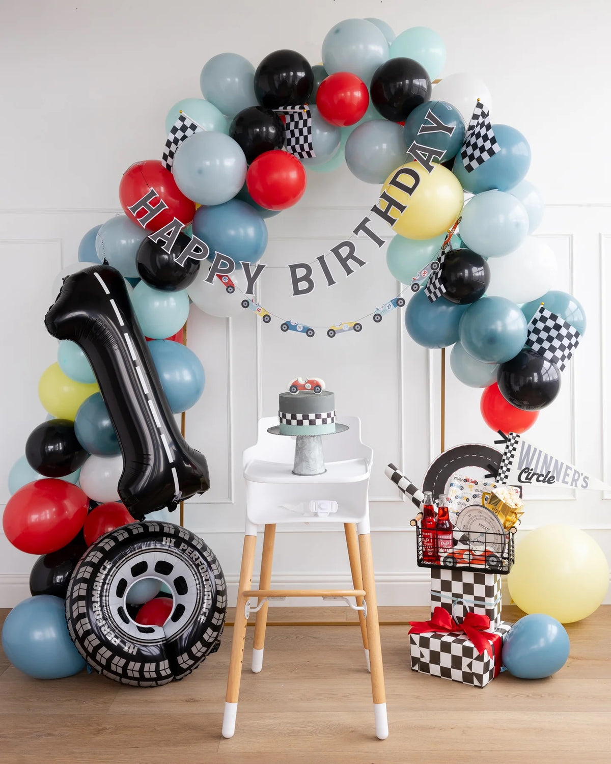 Miles Per Hour Race Pattern Plates placed alongside other race car birthday decorations and party supplies.