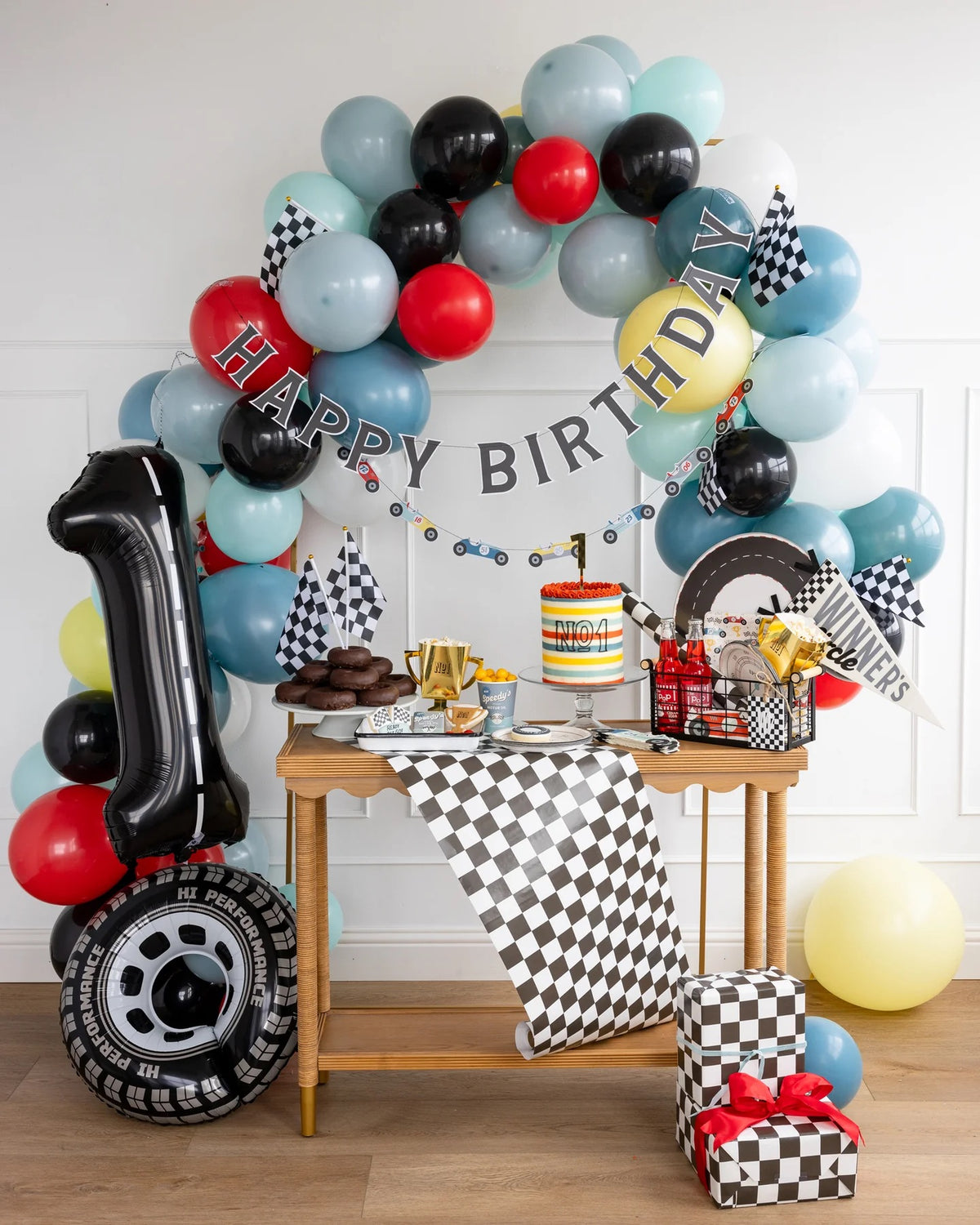 Stylish Miles Per Hour Race Pattern Plates decorating the dining table at a Two Fast Birthday race car-themed party.