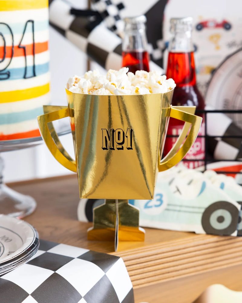 Miles Per Hour Trophy Treat Cups arranged on a table at a Two Fast Birthday car-themed party.