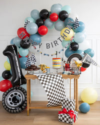 Stylish Miles Per Hour Checkered Flag Table Runner decorating a race car-themed birthday party table.