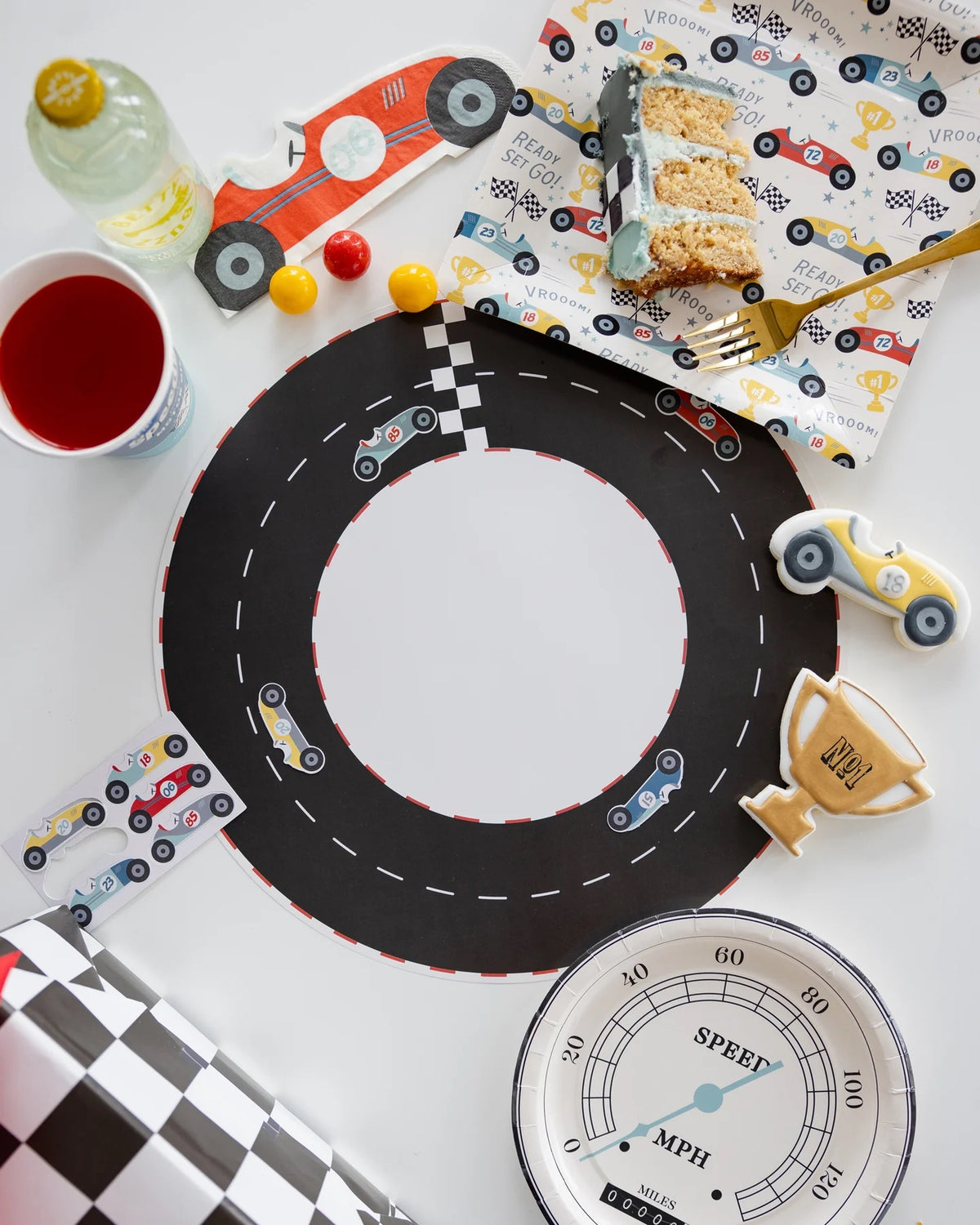 Miles Per Hour Race Track Placemat placed alongside other race car birthday decorations and party supplies.