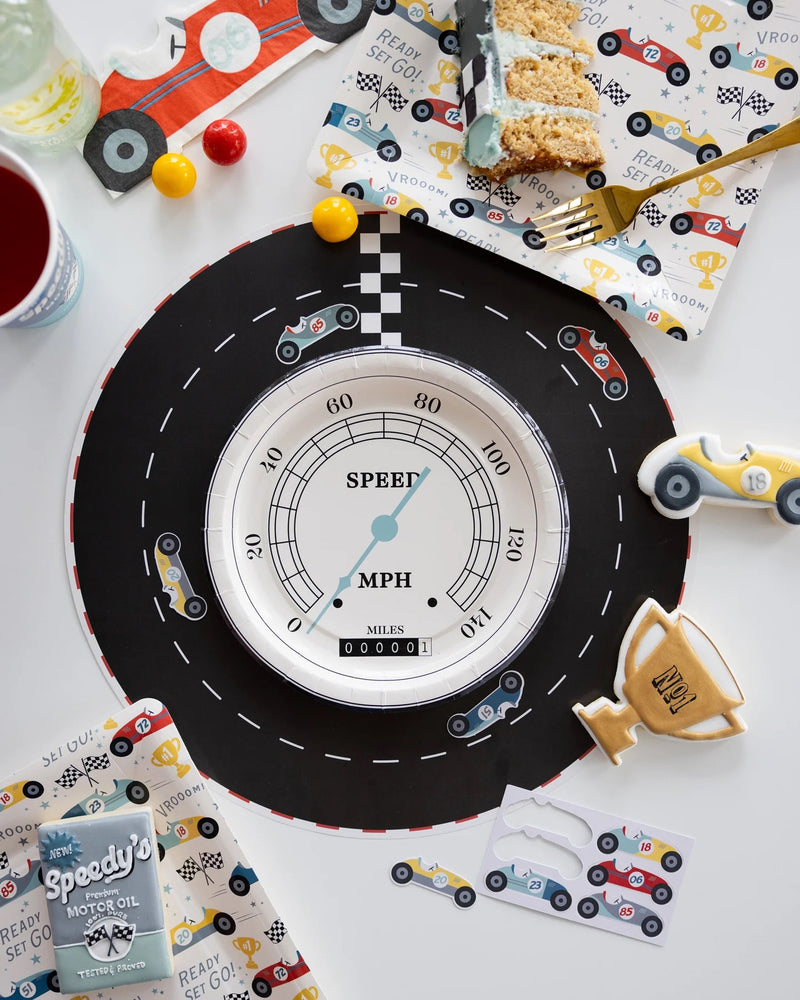 Miles Per Hour Race Track Placemat placed alongside other race car birthday decorations and party supplies.