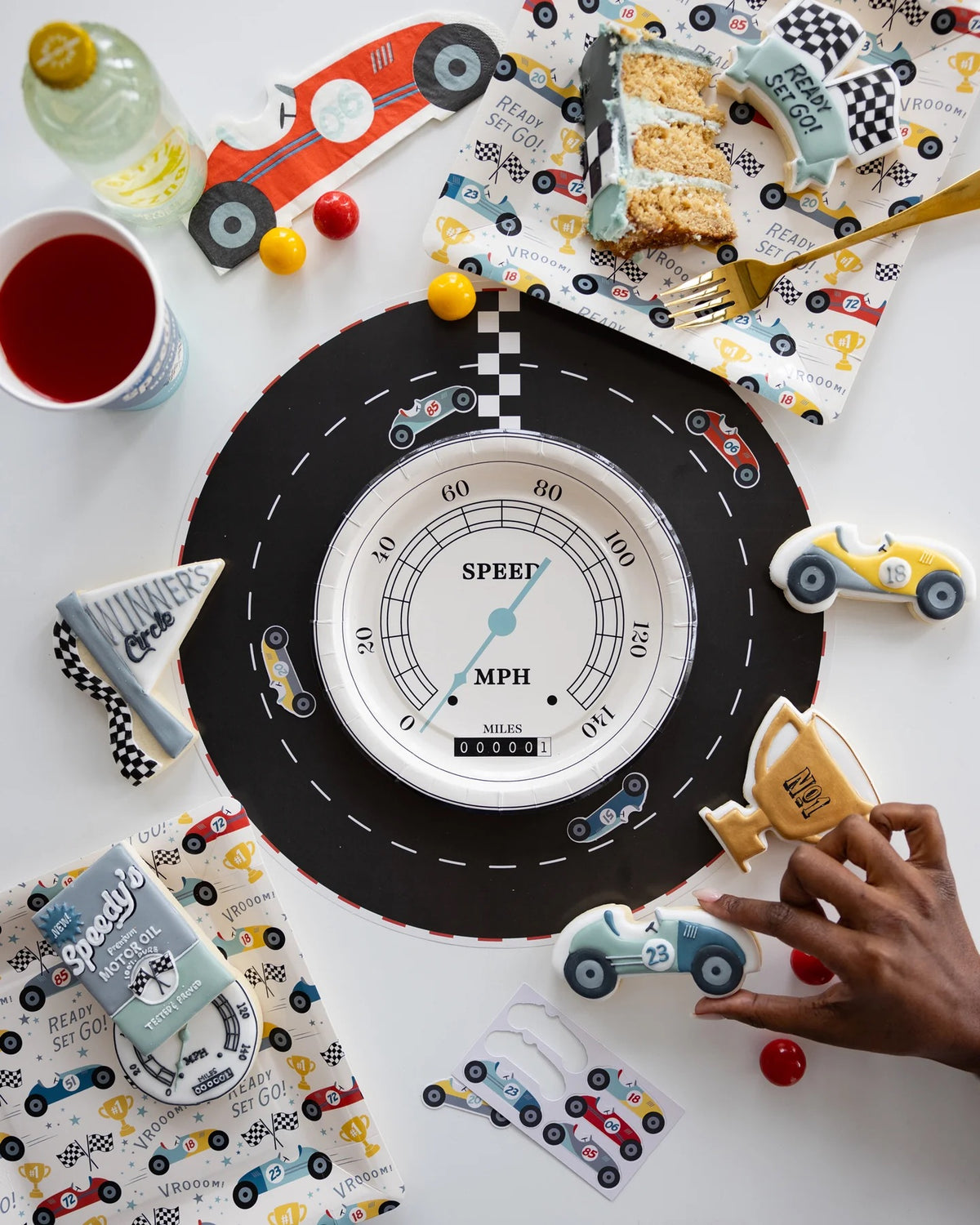 Children enjoying their meals on Miles Per Hour Race Track Placemats at a Two Fast Birthday race car-themed celebration.