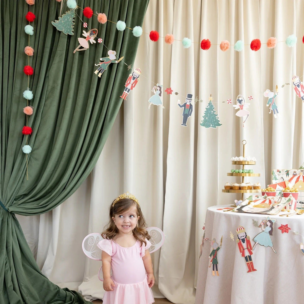 a little ballerina in front of The Nutcracker Party Banner