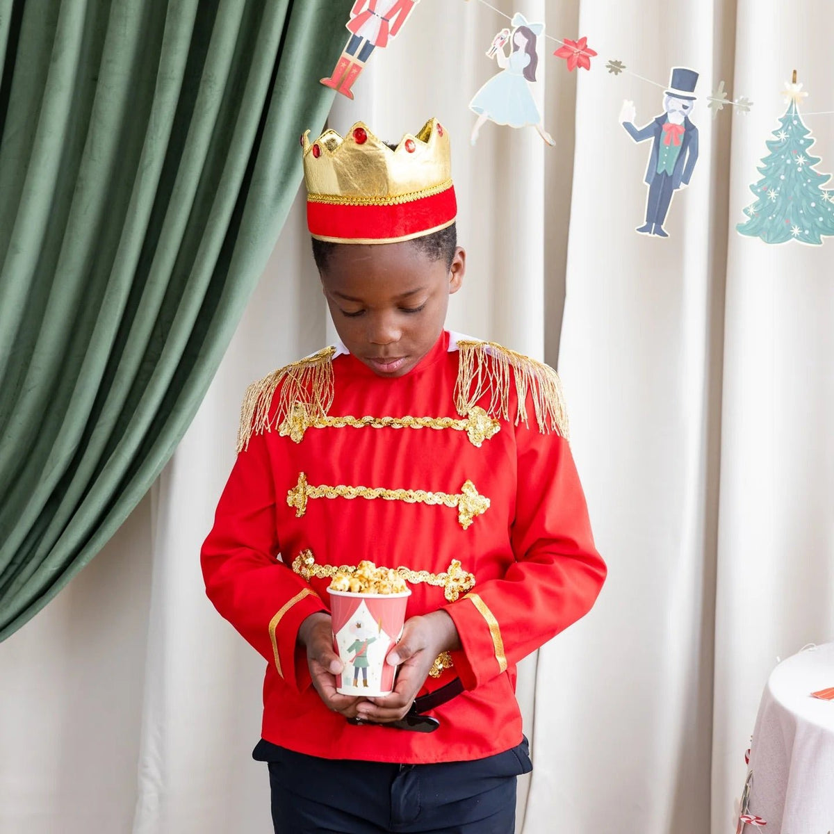 little boy holding a Nutcracker paper cup 