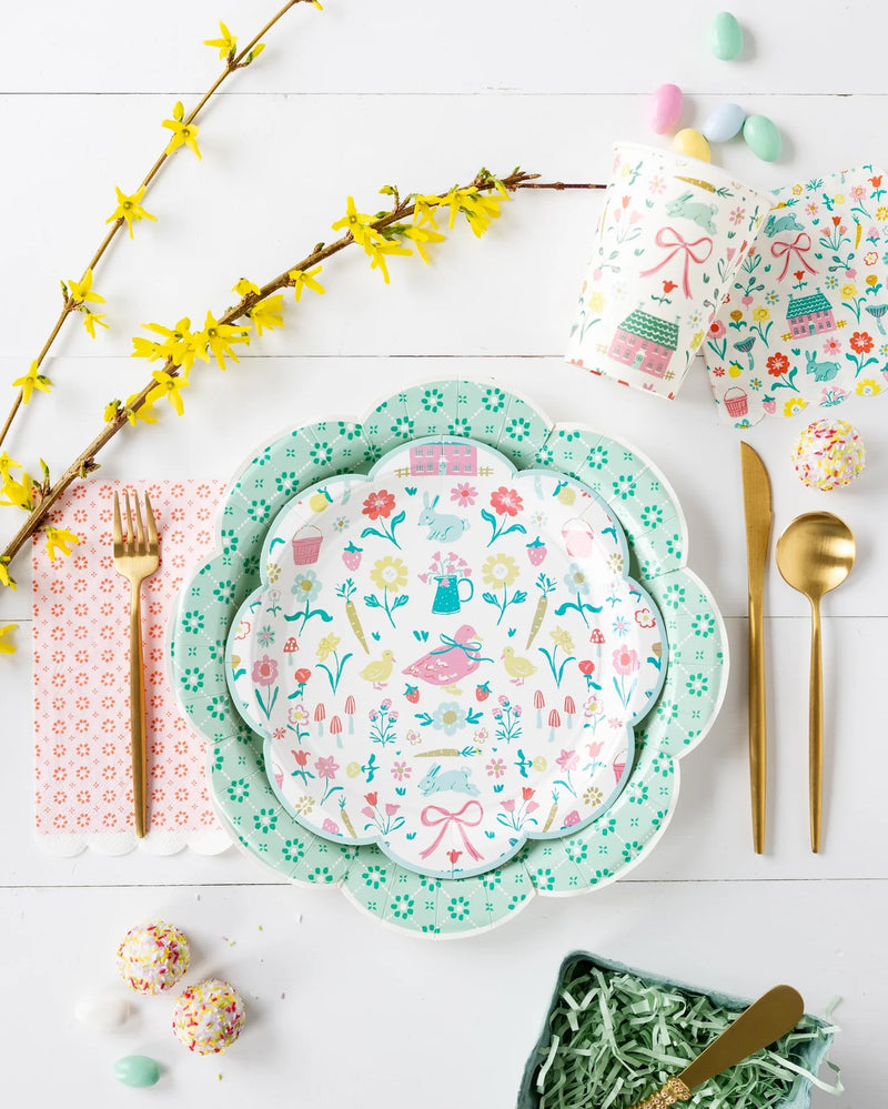 Green Wicker Plates layered with floral napkins and pastel glassware for a charming tablescape.