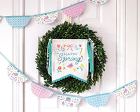 Springtime Cottage Bunting Banner draped across a floral-themed party table.