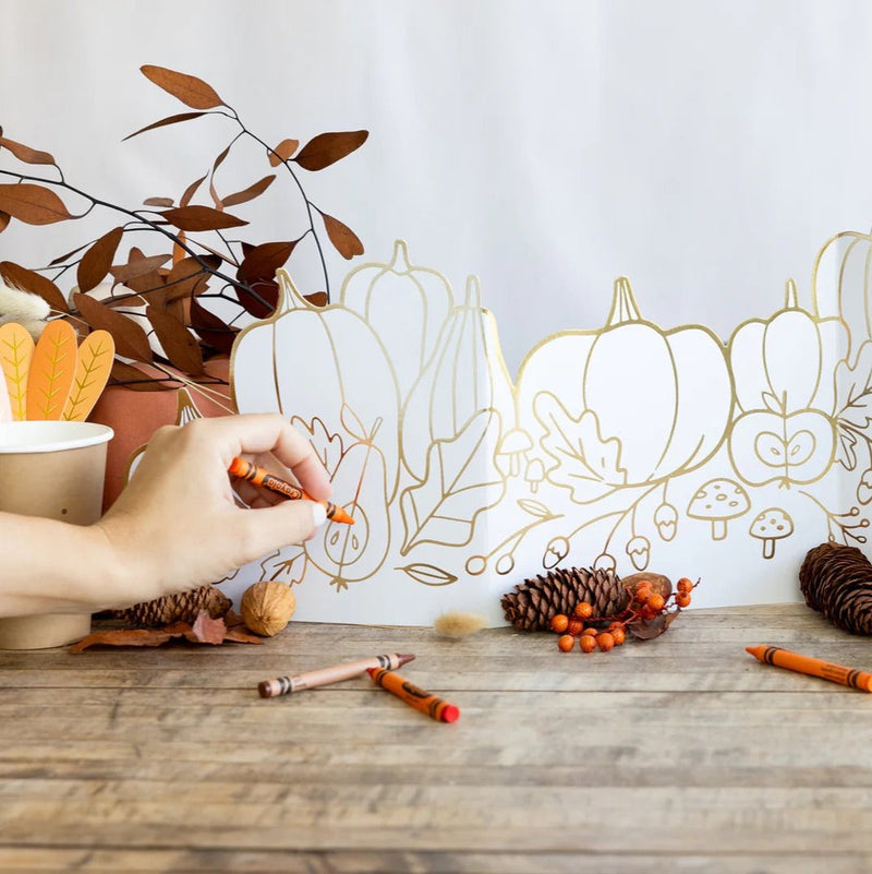 Thanksgiving kids table featuring a gold foil coloring centerpiece, a fun activity for Thanksgiving.