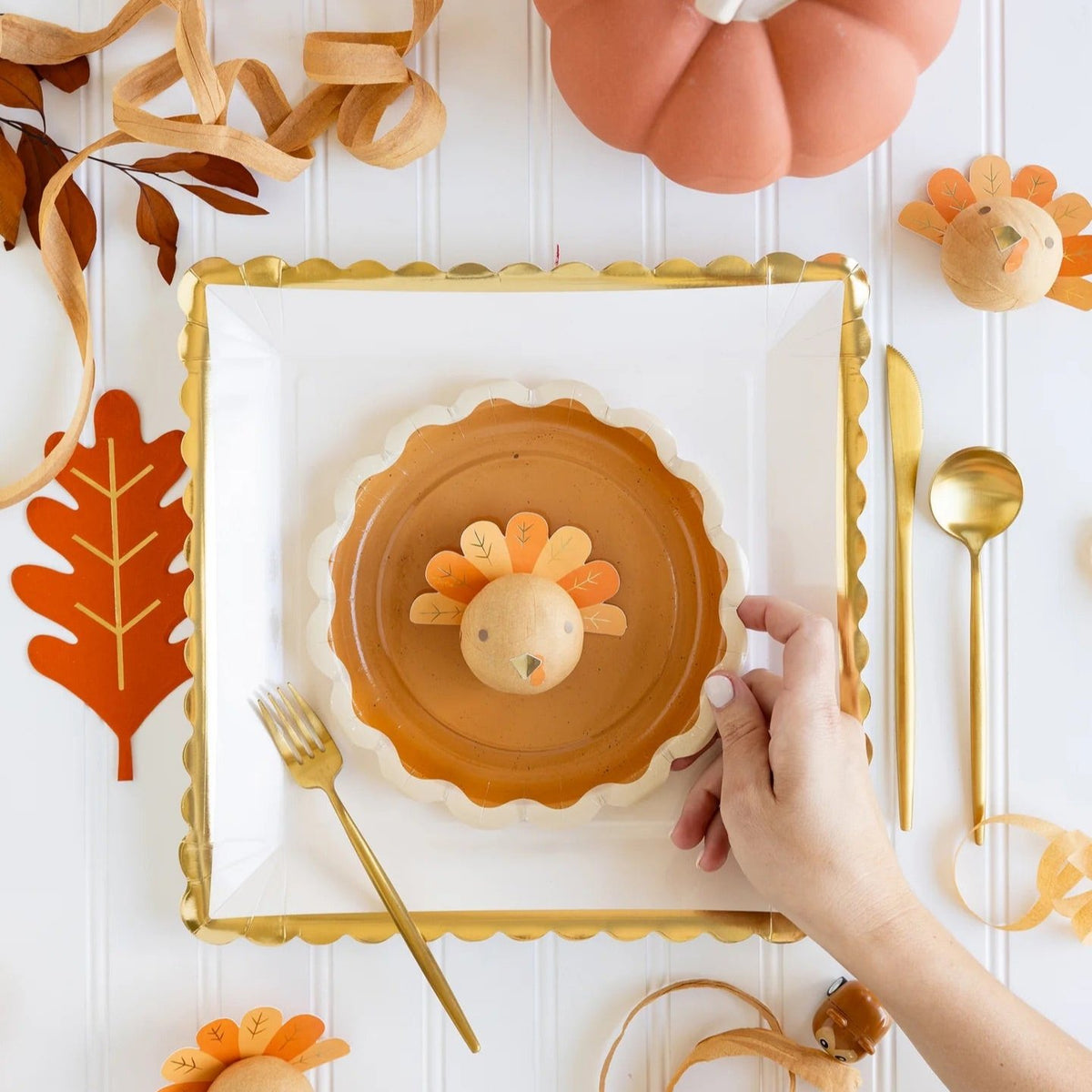 A Thanksgiving kids table setup with a turkey surprise ball, ready to delight little ones as part of their Thanksgiving activities.