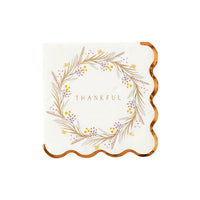 Beautiful Thankful Thanksgiving cocktail napkin with a delicate floral wreath and gold foil scalloped edges, perfect for any Thanksgiving party decor.