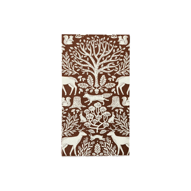 A brown toile fall napkin with intricate designs of trees, deer, and woodland creatures. This Thanksgiving napkin enhances the charm of any fall table setting with its rustic and natural style.