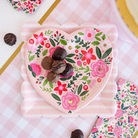 Floral heart-shaped Valentine plates styled on a decorated table with coordinating Valentine’s Day party decor.