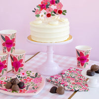 Floral heart-shaped Valentine plates styled on a decorated table with coordinating Valentine’s Day party decor.