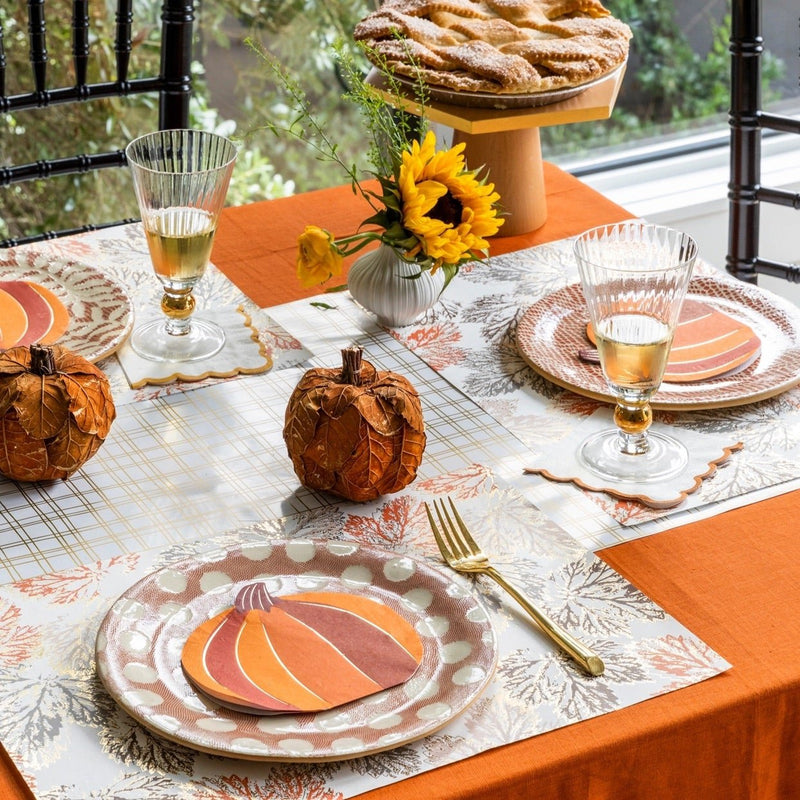 Pumpkin shaped thanksgiving paper napkin on a Fall table settting.