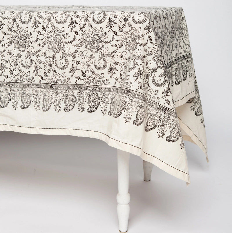 Off-white tablecloth with a gray floral design.