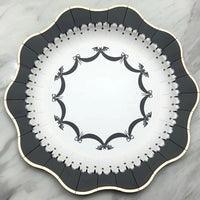 A stylish Halloween plate with a scalloped edge and intricate bat design, perfect for adding a sophisticated touch to your elegant Halloween decorations.