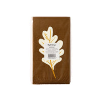 Packaged set of brown fall napkins with an oak leaf design in gold foil, part of a festive Thanksgiving tableware collection.