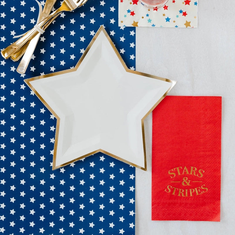 Red dinner napkins with the words stars and stripes in gold lettering. They are perfect for a 4th of Juy party or Memorial Day BBQ.