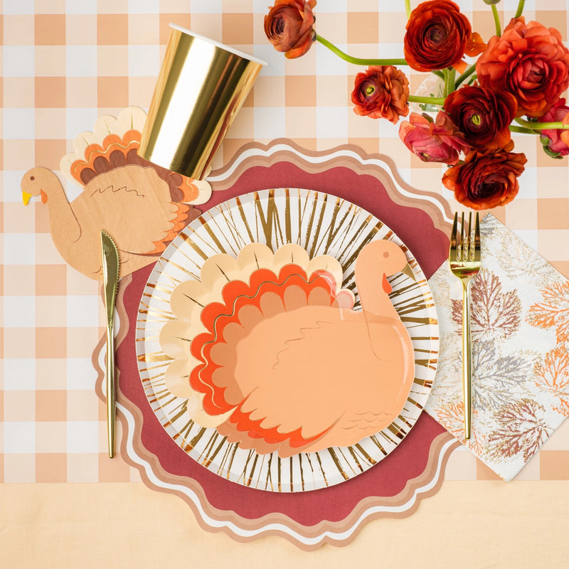 Thanksgiving table setting with a white and gold foil paper plate, surrounded by autumn-themed decor. These 10.5-inch gold paper plates are perfect for Thanksgiving dinner, adding a touch of elegance and sustainability to your holiday celebrations.