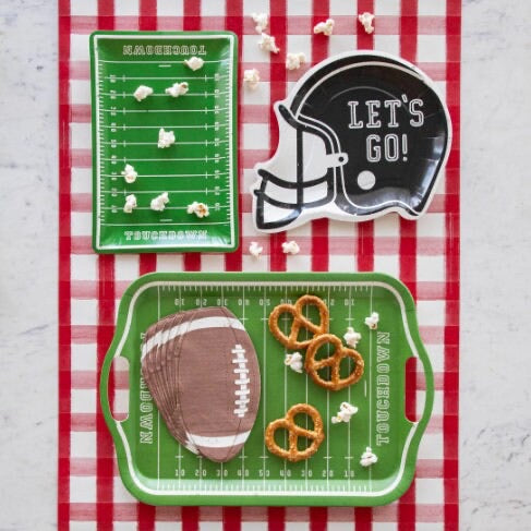 Football party table featuring football helmet shaped paper plates
