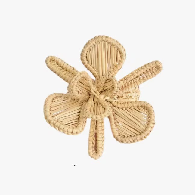 Bring the beauty of the garden to your table with our Flower Napkin Rings. These rattan napkin rings are delicately crafted into a floral design, offering a playful yet sophisticated look for your tableware. Each ring, measuring 3"x 3", adjusts to secure napkins of any thickness. Ideal for everyday elegance or special occasions, these flower napkin rings are essential for a chic, coordinated table.