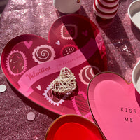 Red heart-shaped box of chocolate paper plates perfect for Valentines Day or an anniversary party